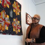 Johyné Geran looks at one of her pieces ahead of the reception for the Black History Month art exhibit at Gallery 1075 in West Sacramento. Geran’s work is the first time that textile work will be shown in the gallery, according to Gallery Curator Evan Harté said. (Photo by Jacob Peterson)