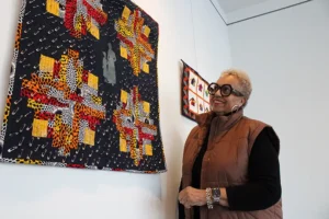 Johyné Geran looks at one of her pieces ahead of the reception for the Black History Month art exhibit at Gallery 1075 in West Sacramento. Geran’s work is the first time that textile work will be shown in the gallery, according to Gallery Curator Evan Harté said. (Photo by Jacob Peterson)