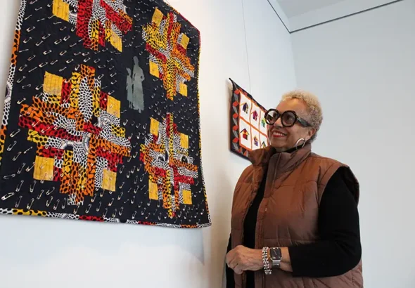 Johyné Geran looks at one of her pieces ahead of the reception for the Black History Month art exhibit at Gallery 1075 in West Sacramento. Geran’s work is the first time that textile work will be shown in the gallery, according to Gallery Curator Evan Harté said. (Photo by Jacob Peterson)